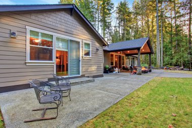 Large back yard with grass.