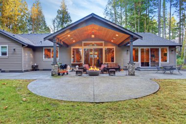 Large back yard with grass.
