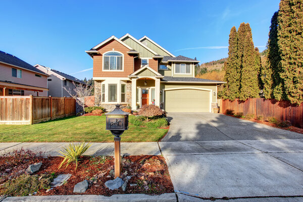 Large modern house with driveway, and garage.