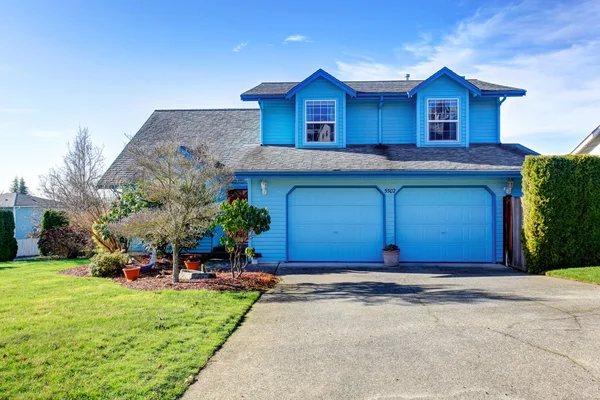 Gran casa azul brillante con dos puertas de grarage . — Foto de Stock