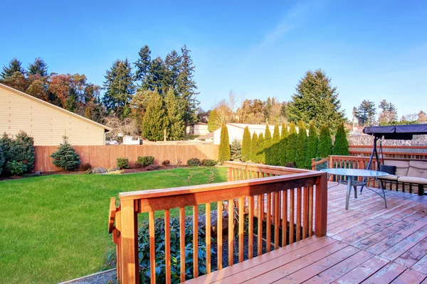 Large back yard with lots of grass and deck. — Stock Photo, Image