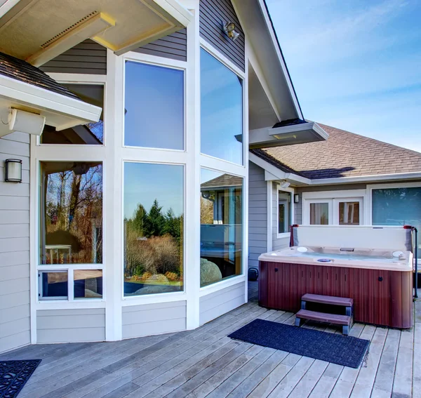 Traditional back deck with tall windows, and jacuzzi tub. — Stock Photo, Image