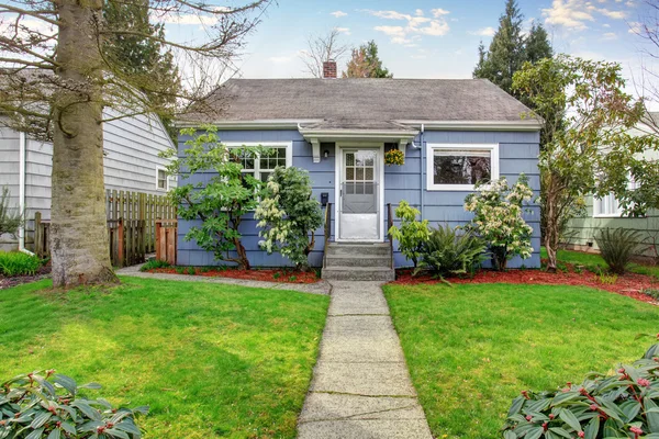 Authentic blue house with lots of greenery. — Stock Photo, Image