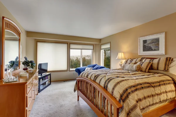 Large bedroom with stripped bedding. — Stock Photo, Image