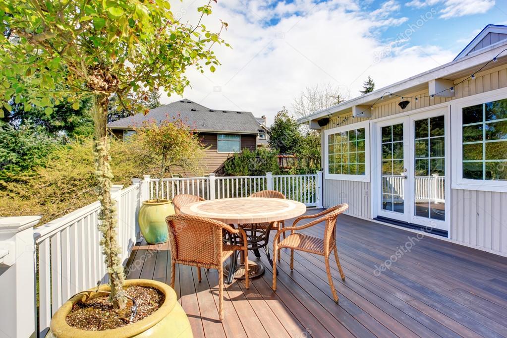 Nice furnished back deck with plants.