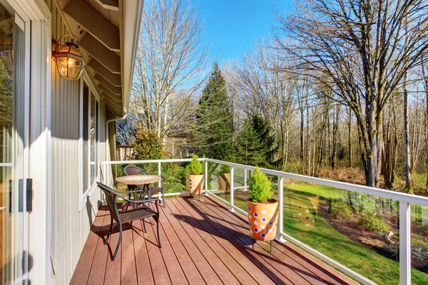 Nice back porch with glass fencing and chairs. — Stock Photo, Image