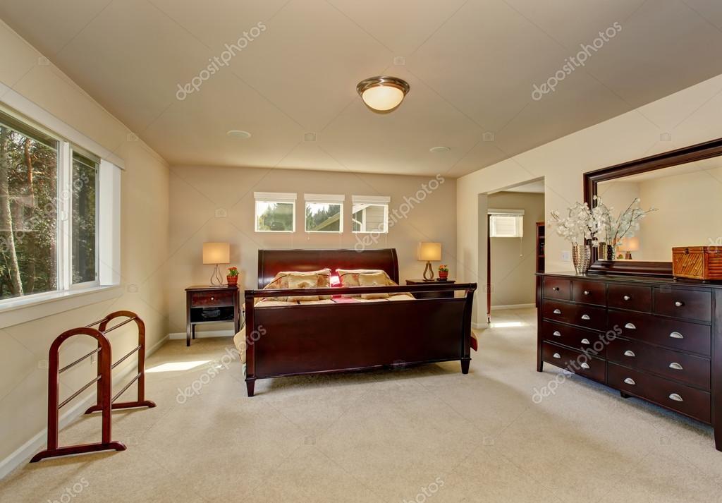 Elegant Master Bedroom With Wooden Bed Frame Stock Photo
