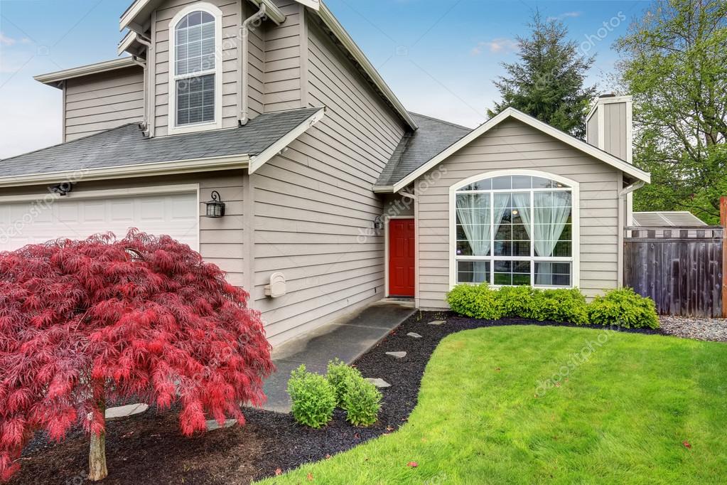 Modern Home With Red Door And Light Grey Exterior Stock