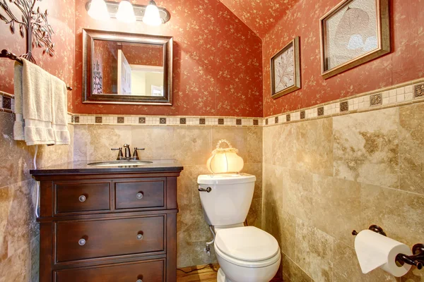 Well decorated half bathroom with red gold interior. — Stock Photo, Image