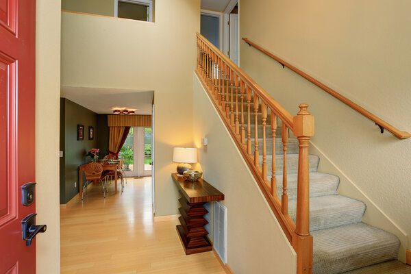 Modern entry way to home with carpet staircase.