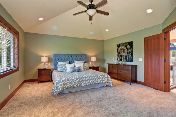 Large bedroom with green interior.
