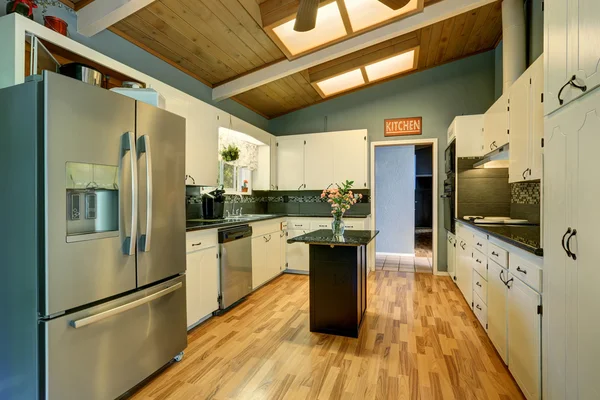 Modernized kitchen with blue walls.