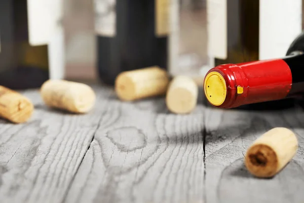 wine bottle with corks on wooden planks with copy space, shallow dof