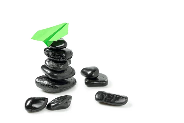 Green Paper Plane Balanced Black Stones Success Concept — Stock Photo, Image