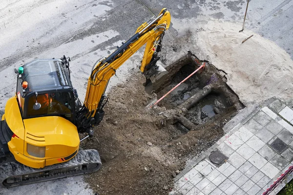aerial view of excavator digging a hole