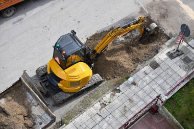 aerial view of excavator digging a hole