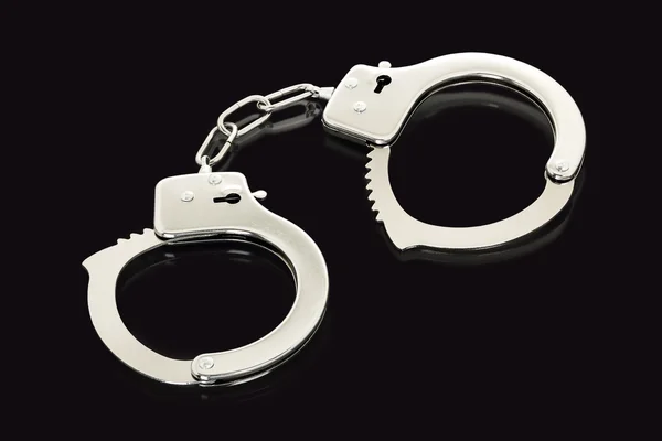 Handcuffs on black — Stock Photo, Image