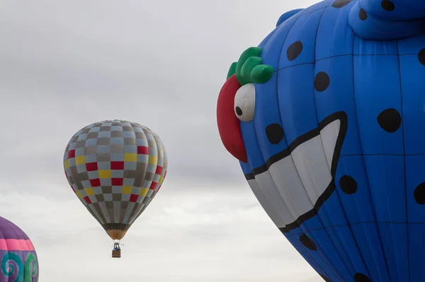 Large Blue Monster Balloon Looks Smaller Rising Balloon Wants Eat — Stock Photo, Image