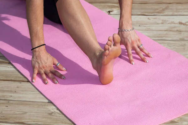 Women's bare feet connection on yoga cushions - Stock Image - F017