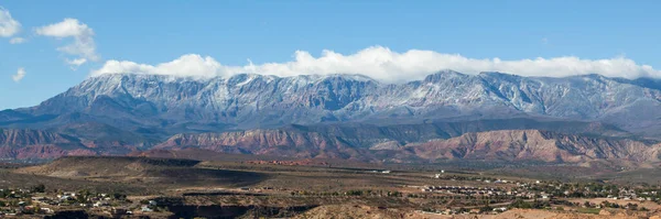 Signal Peak and the Pine Valley Mountains with morning sunshine showing a dusting of snow and low clouds near La Verkin, Utah.