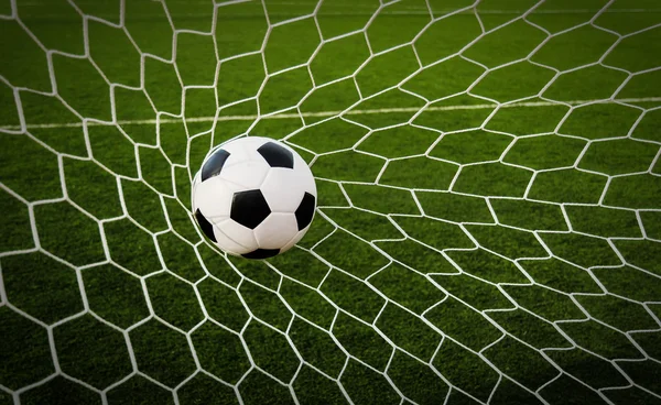 Football ball in goal net Royalty Free Stock Images