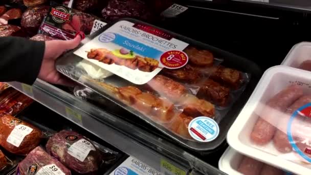 Woman selecting Kabobs brochettes chicken breast inside Walmart store at meat department — Stock Video