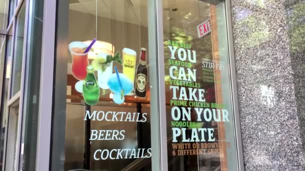 You can take on your plate sign on glass of restaurant at downtown Vancouver — Stockvideo