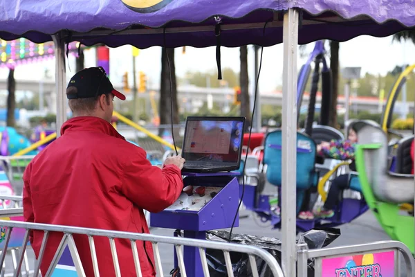 Le travailleur contrôle la machine au carnaval des Amusements de la côte ouest — Photo