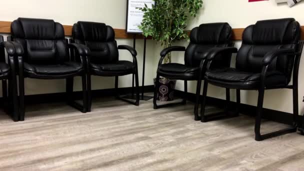 Motion of empty chair for patient waiting place inside BC medicial office — Stock Video