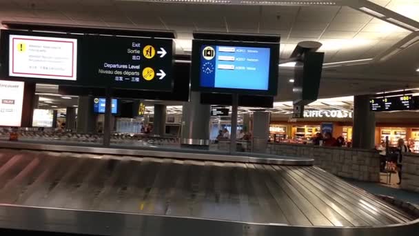 Réclamation de bagages à l'aéroport YVR intérieur avec bagages tournant autour du convoyeur . — Video