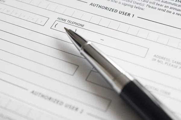 Blank credit application form and pen Stock Image