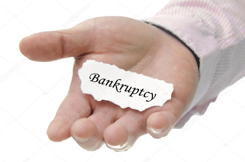 Business man holding bankruptcy note on hand 
