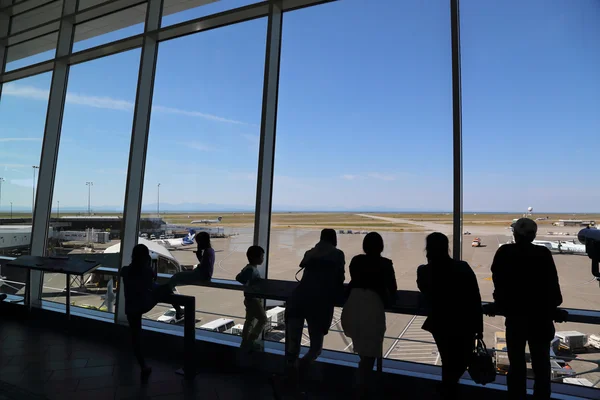 People inside YVR airport watching air canada airplane