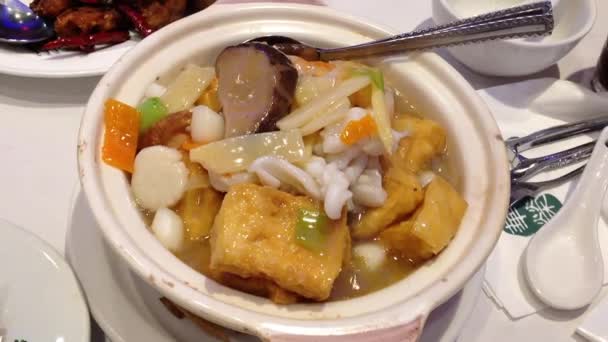 Eating chinese food called seafood with tofu hot pot — Stock Video