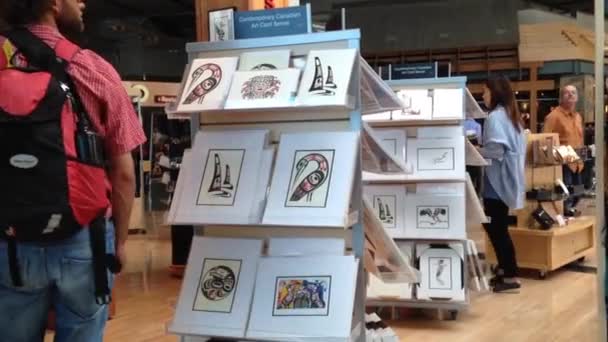 One side of passengers inside gift shop at YVR airport — Stock Video