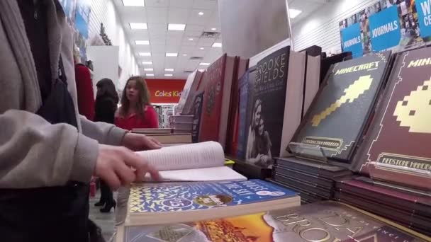 Closeup woman hand going to flip page of book — Stock Video