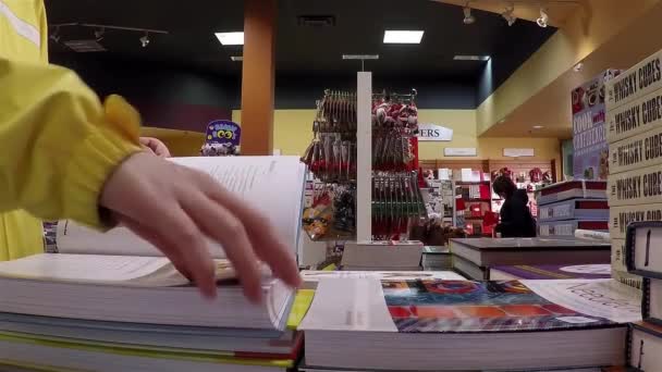 Closeup woman hand going to flip page of book — Stock Video