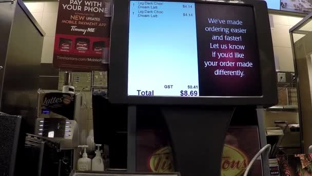 Close up screen of custmer buying hot chocolate at check out counter — Stock Video