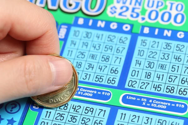 Close up woman scratching lottery ticket called bingo — Stock Photo, Image