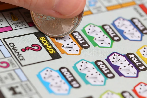 Close up woman scratching lottery ticket — Stock Photo, Image