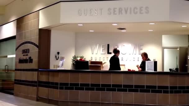 Two Beautiful Receptionist Behind The Service Desk At Guest