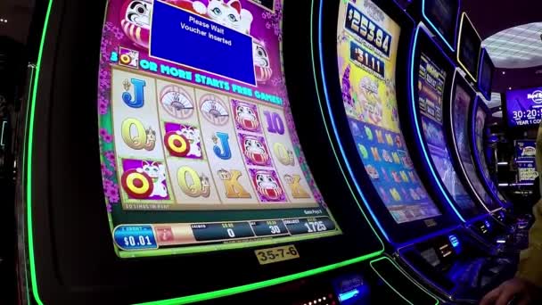 Close up people playing slot machine inside Hard Rock Casino in Coquitlam BC Canada. — Stock Video