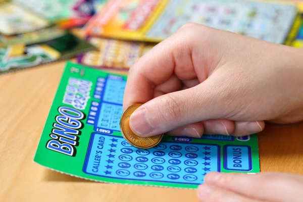 Close up woman scratching lottery tickets. — Stock Photo, Image