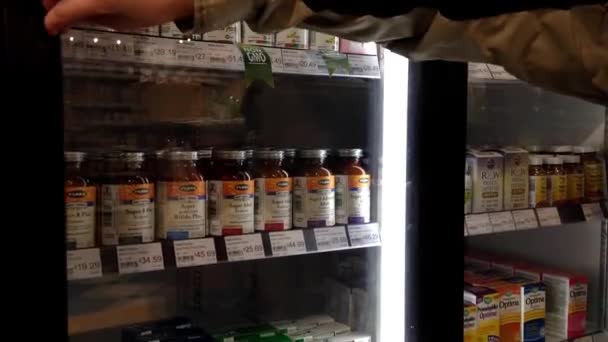 女人选择保健食品，在杂货店在高贵林公元前加拿大. — 图库视频影像