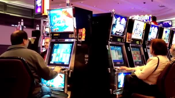 One side of people playing slot machine inside Hard Rock Casino in Coquitlam BC Canada — Stock Video