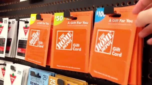 Woman picking one hundred dollar the homedepot gift card — Stock Video