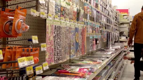 Woman choosing scrapbooks inside Walmart store in Burnaby BC Canada. — Stock Video