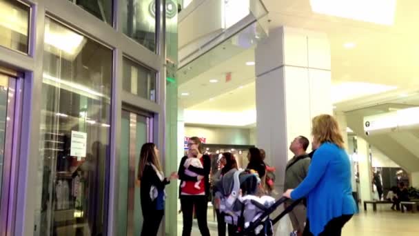 One side of shopping mall with people waiting the elevator — Stock Video