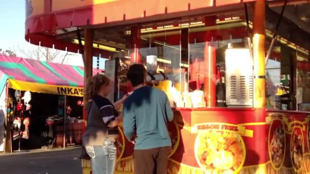 People buying fries at food booths inside the West Coast Amusements Carnival — Stock Video