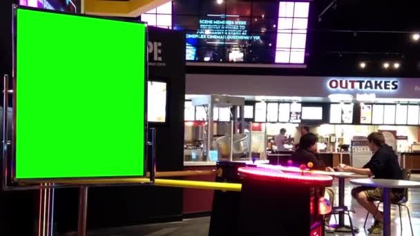 Green billboard for your ad beside video game at silvercity vip cineplex — Stock Video